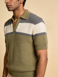 Model wearing The Long Field honeycomb-knit colourblock polo in olive, ecru and charcoal grey