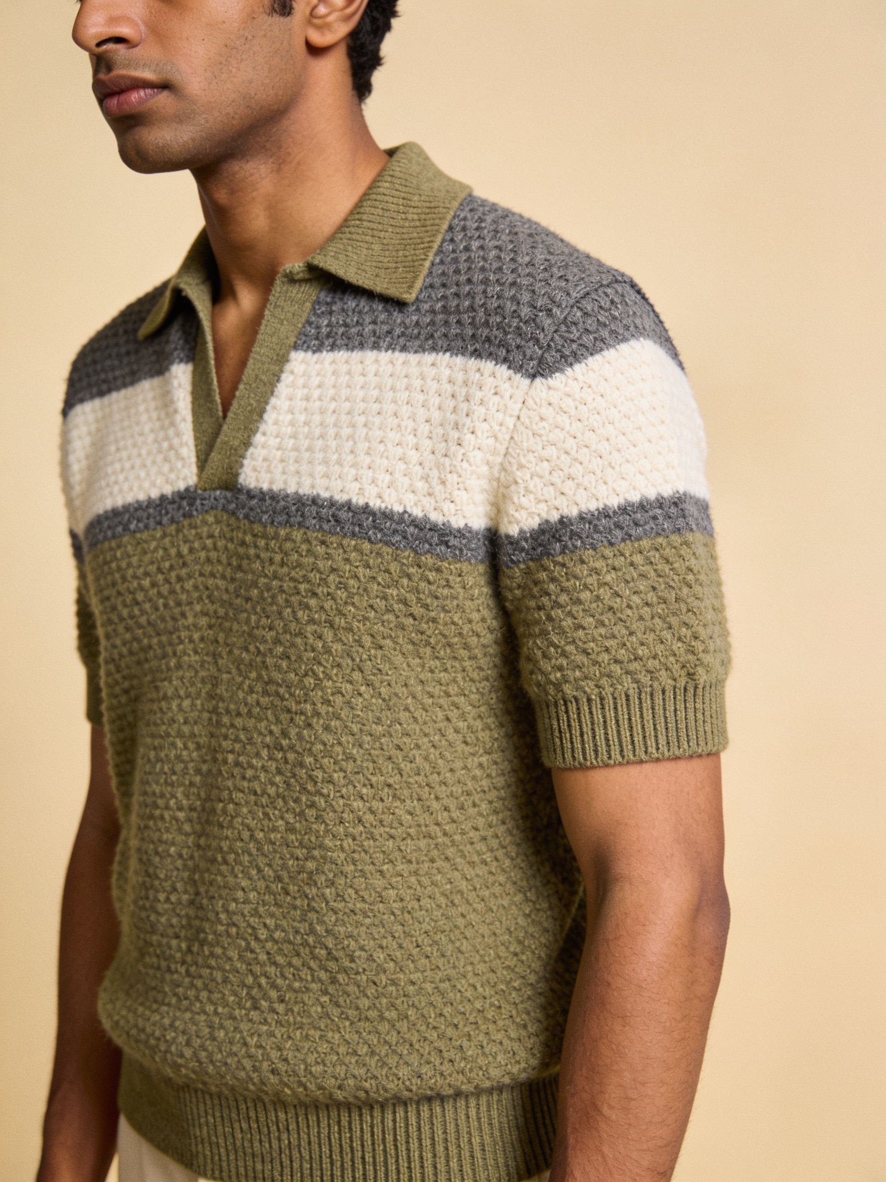 Model wearing The Long Field honeycomb-knit colourblock polo in olive, ecru and charcoal grey