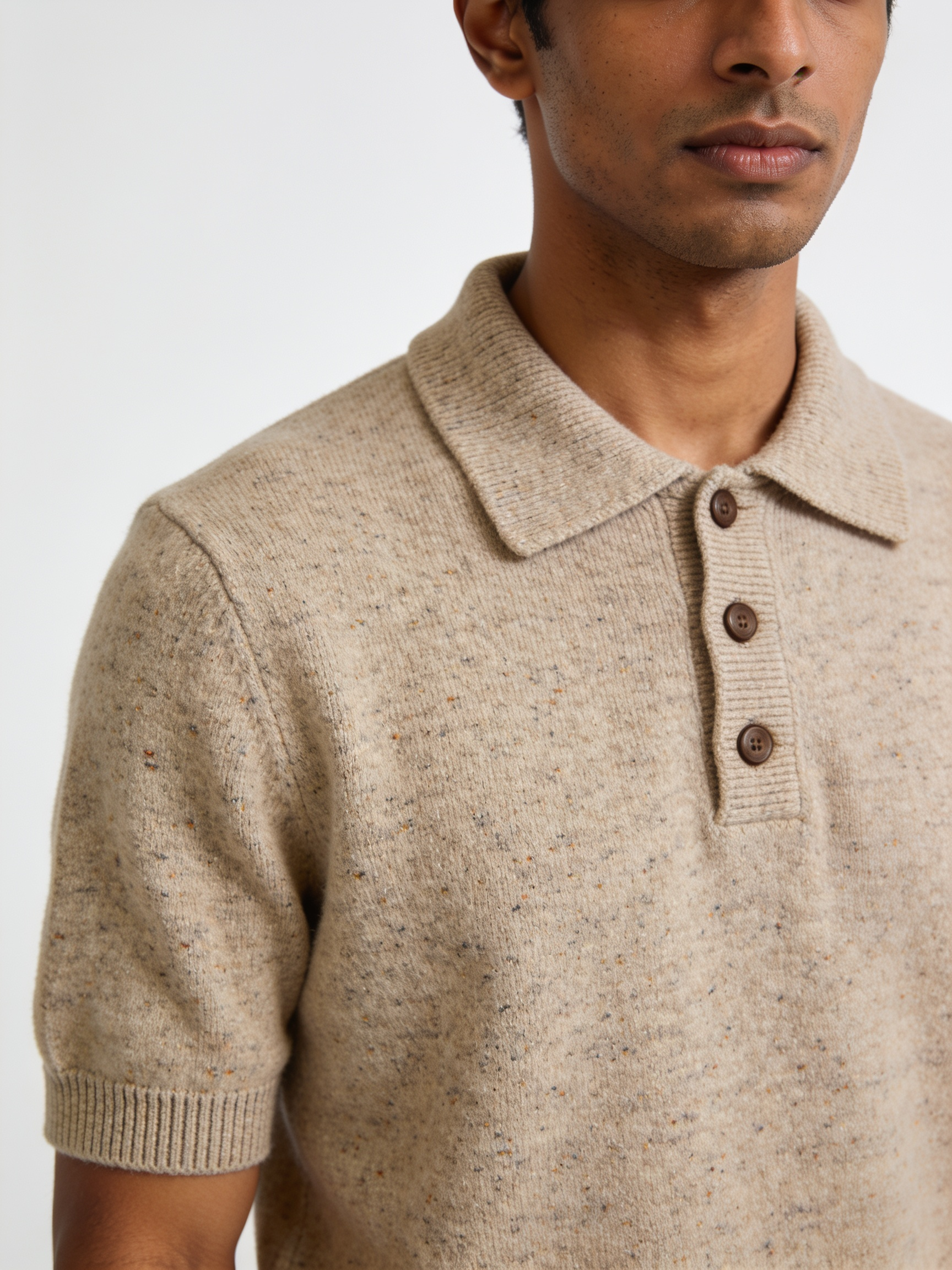Model wearing The Weather Report donegal knit polo in oatmeal, flecked with rust and slate