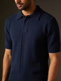 Model wearing The Last Train knit polo in midnight navy with an extended ribbed placket and tonal buttons
